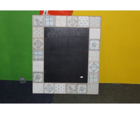 A modern chalkboard, with tile effect border. 74 cm x 62 cm.  CONDITION REPORT: Generally in good used condition.