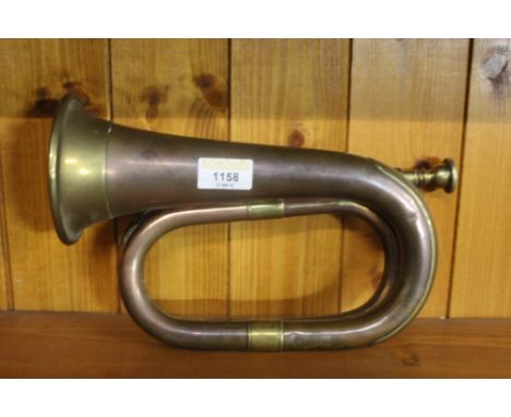 A copper and brass bugle, traditional form.  27.5 cm.  CONDITION REPORT: Some minor denting etc.  The bugle retaining its mou