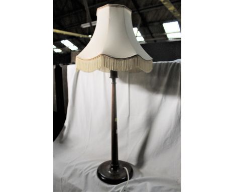 A 20th century oak table lamp of turned form, 55 cm to the fitting.  CONDITION REPORT: Good condition, the shade has some sli