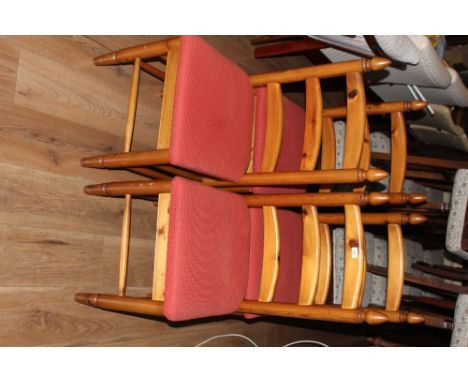 A set of four modern pine ladder back dining chairs, the seats upholstered in red material, 100 cm with seat height of 46 cm.
