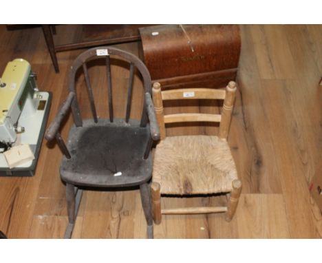 A child's dark stained elm rocking chair of Ercol design and a child's pine rush seated chair