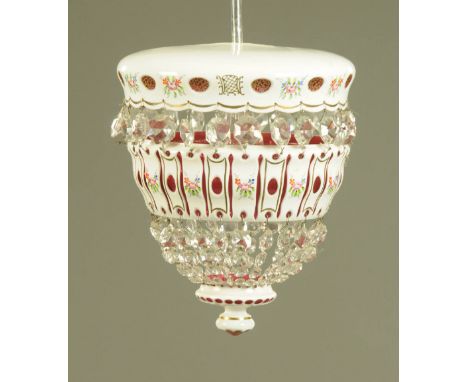 A milk glass overlay ruby tinted hanging light fitting with faceted glass drops, diameter +/- 28cm