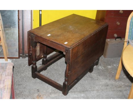 An 18th century oak gate leg table, with baluster turned supports linked by plain stretchers. 69 cm x 91 cm x 59 cm.   CONDIT