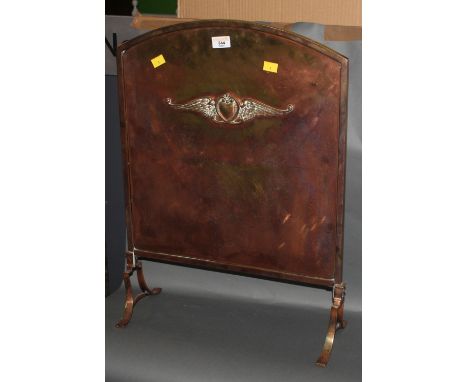 An early 20th century copper fire screen, of arched form with applied winged motif. 61 cm x 45 cm. CONDITION REPORT: Some wea