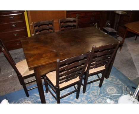 A modern stained elm kitchen table, of rectangular form with two short end drawers and shaped rails, raised on in sized squar