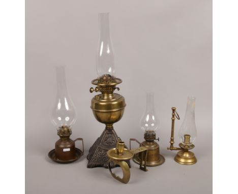 A quantity of brass and glass oil lamps to include chamber lamp examples etc.