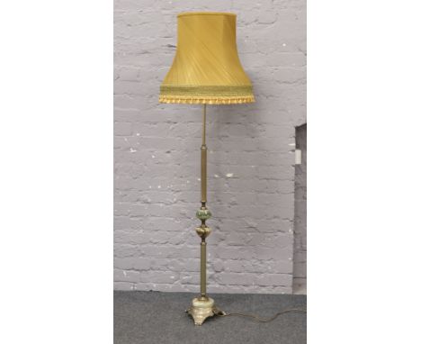 A reeded brass and onyx standard lamp with mustard shade.