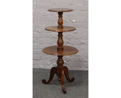 A small Victorian mahogany three tier dumb waiter on tripod base.
