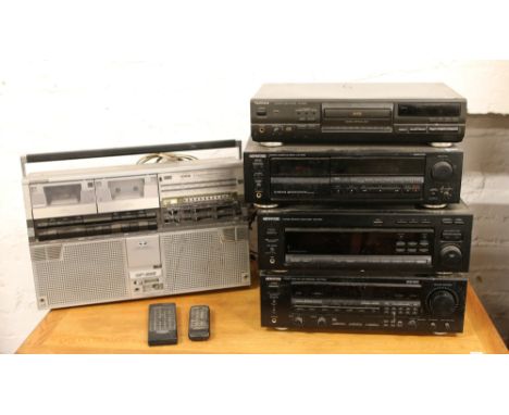 A Kenwood stacking system along with a Technics CD player and a Sharp GF 555 stereo / tape recorder.