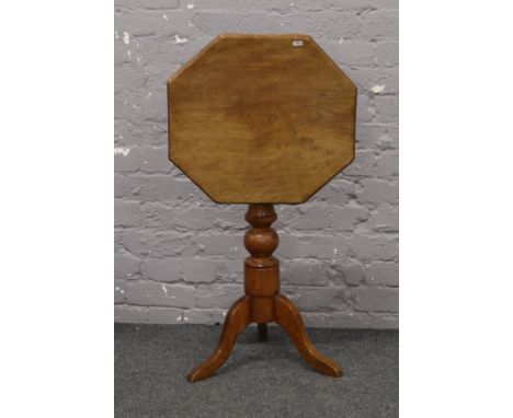 A mahogany tilt top occasional table with tripod base.