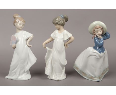 Three Nao ceramic figures of girls.
