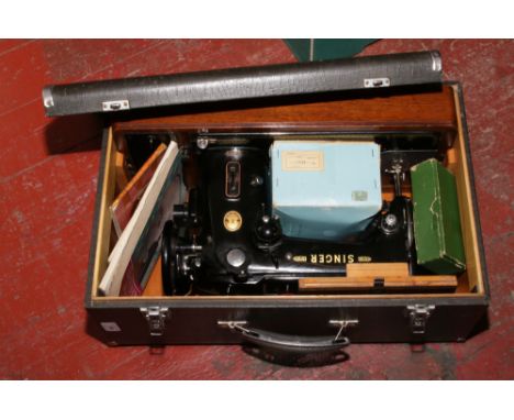 An electric Singer sewing machine in original case, model number EJ475379.
