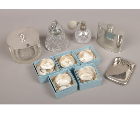 A box of silver plated items including napkin rings, hip flask, perfume atomiser, desk top lighter etc.