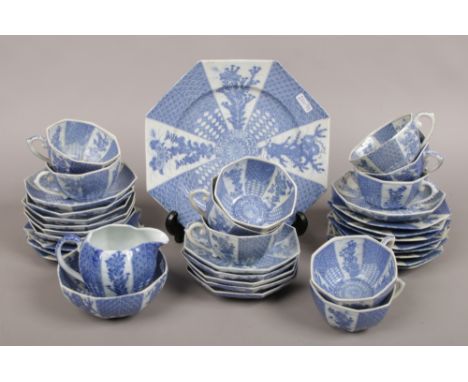 A Japanese transfer printed porcelain tea service with alternating blue and white panels, comprising foliage, leaves and trel