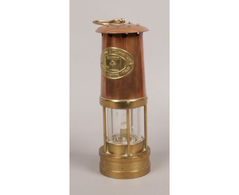 A Welsh copper and brass miners safety lamp by E. Thomas and Williams Ltd.