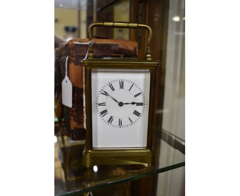 An old brass carriage clock,&nbsp;with push button repeat, striking on a gong, height including handle 18cm, the base numbere