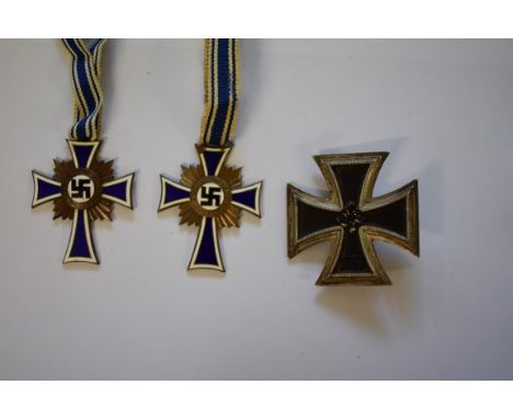 Two World War II German enamel Mother's medals;&nbsp;and an Iron Cross 1st Class. 