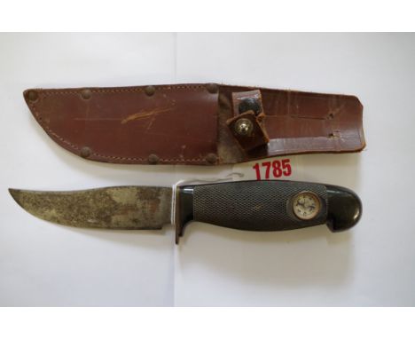 A vintage knife and leather sheath,&nbsp;the handle inset with compass.&nbsp; 