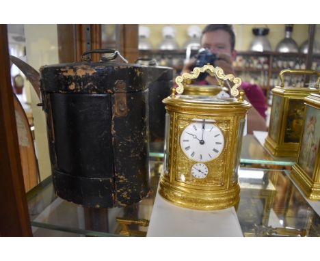 A good 19th century gilt brass oval carriage clock,&nbsp;by J Soldano,&nbsp;with alarm and bell strike, the platform and move