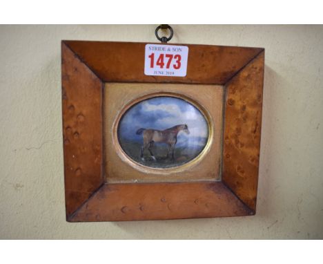 A small Georgian silk embroidered panel, 9.5 x 13cm oval; together with a small oil of a horse in a landscape, 5.5 x 7cm oval