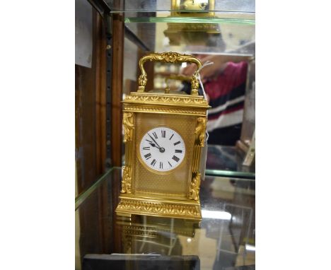 A good gilt brass carriage clock,&nbsp;with push button repeat, striking on a gong, height including handle 17cm.&nbsp;