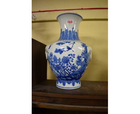 A&nbsp;Chinese blue and white&nbsp;twin handled vase, Kangxi six character mark, painted with a phoenix and other birds amids