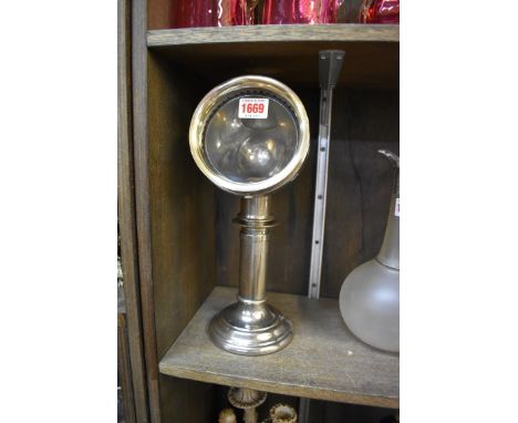 An early 20th century nickel plated student's reading lamp,&nbsp;with spring loaded candle. 