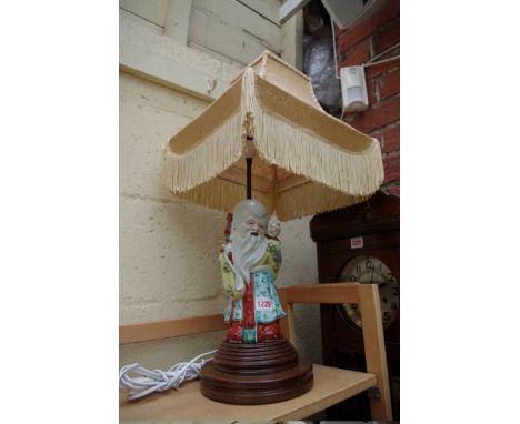 A Chinese famille rose figural table lamp,&nbsp;the figure 26cm high.&nbsp; 