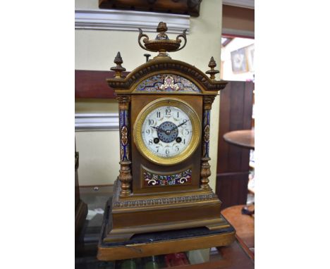 A late 19th century gilt brass and champleve enamel clock,&nbsp;36.5cm high, on gilt stand. 