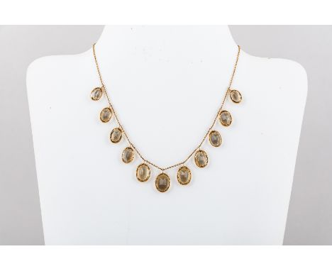 A citrine and yellow metal necklace, the eleven oval mixed cut  stones graduating in size from 13mm to 10mm  and individually