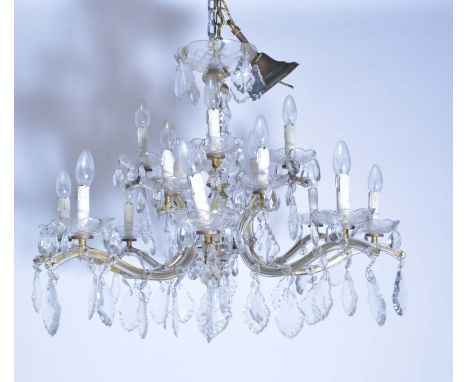 A pair of cut glass sixteen-light chandeliers, 20th century, with eight double light scroll branches, each with faceted drops