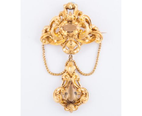 A Victorian yellow metal hollow scroll design brooch, claw set with an oval mixed cut citrine to centre. Pendant dropper to b
