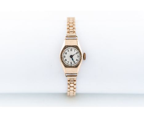 Rotary - A lady's 9 carat gold wristwatch, circular champagne baton dial with quarter arabics in a 9 carat yellow gold case, 