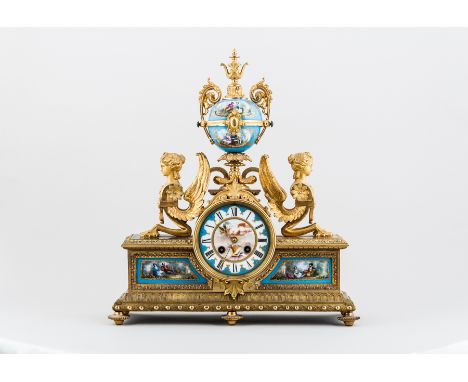 A Louis XVI style ormolu and Sevres style Bleu Celeste mantel clock, French, Third Republic, urn finial, the drum flanked by 
