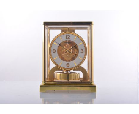 A Jaeger Lecoultre Atmos clock, lacquered brass case, 23cms, complete with wall bracket.