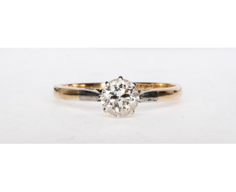 A diamond solitaire ring, the old brilliant cut stone claw set in a traditional yellow and white metal mount with spear point
