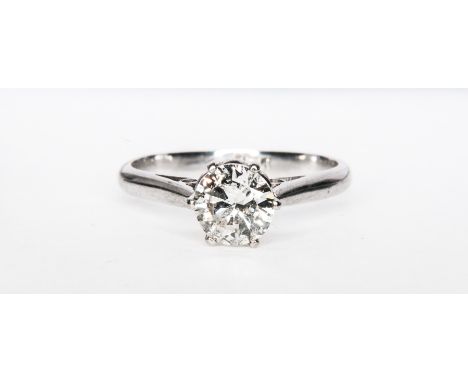 A diamond solitaire ring, the brilliant cut stone claw set in a traditional white metal mount with plain spear point and tube