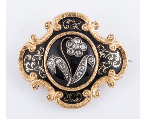 A Victorian yellow metal mourning design brooch with black onyx domed centre having an applied diamonds (17), old cut stones 