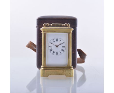 A small French brass cased carriage clock, white enamel dial, platform escapement, 9cm in a morocco carry case.