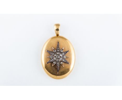 A Victorian yellow metal plain polished oval locket, 50mm x 40mm with applied twelve ray star to centre bordered with blue en