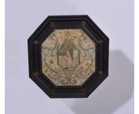 An octagonal needlework panel, late 17th Century, Trompe L'oil design as a miniature, depicting Prelate at prayer, surrounded