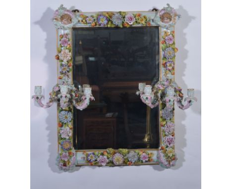A German porcelain framed girandole, rectangular bevelled plate, the frame encrusted with chrysanthemums, roses, other flower