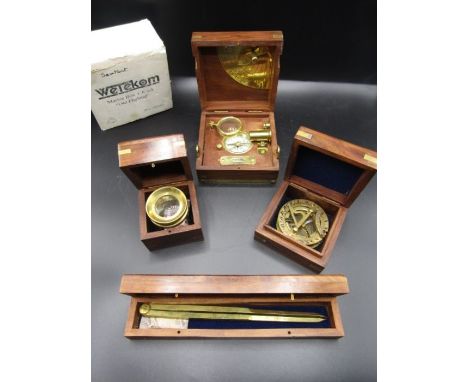 Nautical navigation tools -a sextant, brass magnifier, brass compass and chart dividers in wooden boxes with brass anchor inl