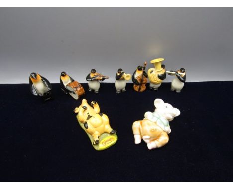 7 ceramic penguins playing instruments, a Colmans pig and another pig