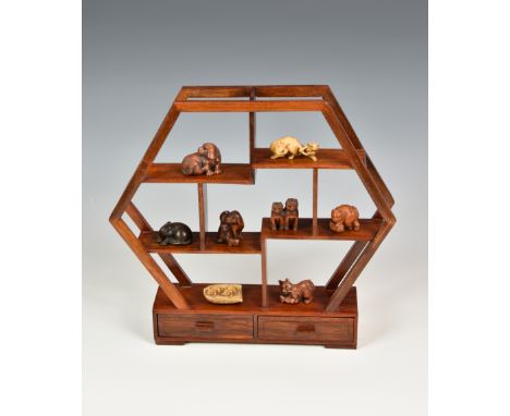 A collection of eight 20th century / modern Japanese carved netsuke with display stand comprising of dogs, cats and mice, mos