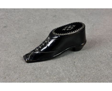 An elegant Victorian papier maché snuff box fashioned as a shoe having ornate pewter inlay, highlighting the pattern and lace