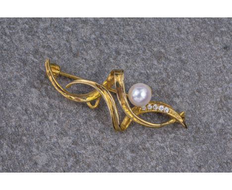 A 9ct yellow gold, cultured pearl and diamond brooch, the brooch consisting of yellow gold swirls, set with a cultured pearl 