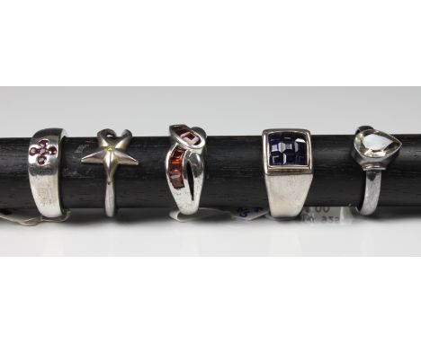 A collection of silver rings set with various gemstones comprising yellow diamond; smoky quartz; garnet; blue sapphire; ruby,