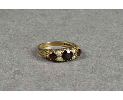 An antique style 9ct gold, garnet and seed pearl ring size P½.