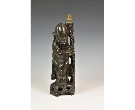A Chinese carved hardwood figure of Shou Lao with inset glass eyes and bone teeth, designed and mounted as a lamp, mid-20th c